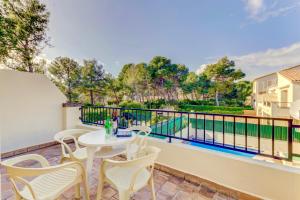 a patio with a table and chairs on a balcony at Beach Villa Can Bauza in Port de Pollensa