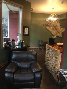 a waiting room with a leather chair and a counter at Sitka Hotel in Sitka