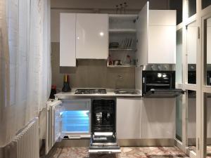 a kitchen with white cabinets and an open oven at Ca' Terlotta in Venice +22 photos