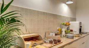 a kitchen with a counter with food on it at YH SUITE 131 in Rome