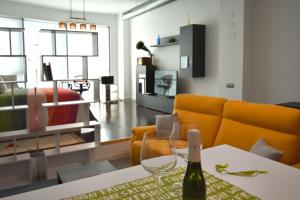 a living room with a bottle of wine on a table at Gramophone Loft in Rivas-Vaciamadrid