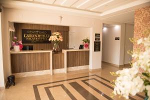 a lobby of a pharmacy with flowers on the counter at Laranjeiras Palace Hotel in Laranjeiras do Sul