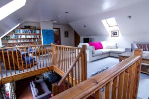 a living room with a staircase and a couch at Ceridwen Holiday Home in Llandysul
