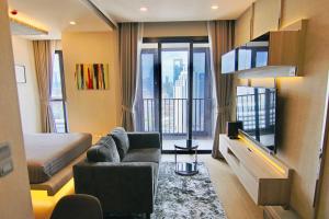 a hotel room with a bed and a couch and a television at Luxurious & Romantic in the Heart of BKK. MRT/BTS! in Bangkok