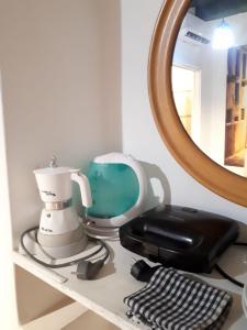 a table with a hair dryer and a phone on a shelf at Comfort Murano room in Murano