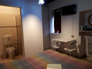 a bedroom with a bed and a table and a desk at Comfort Murano room in Murano