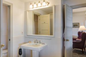 a bathroom with a sink and a mirror at First Colony Inn in Nags Head