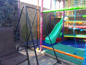 a playground with a slide and a chair at Guest House Barkhat in Zatoka
