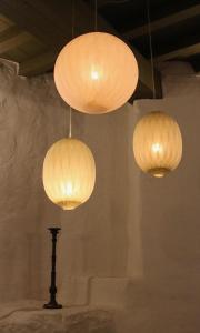 three lights hanging from a ceiling with a pole at De Pelsertoren in Zwolle