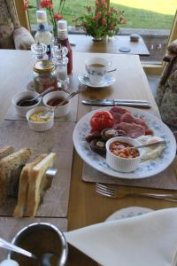 a wooden table with a plate of food on it at Highfield in Hay-on-Wye