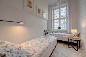 Кровать или кровати в номере Apartamenty Mariacka