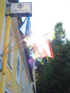 a group of flags flying outside of a hotel at Hotel Die Residenz in Schloss Rosenau