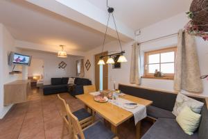 a living room with a table and a couch at Bio-Bergbauernhof Hubgut in Zell am See