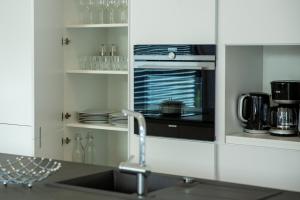 a kitchen with a sink and a stove top oven at Salzburg Loft in Salzburg