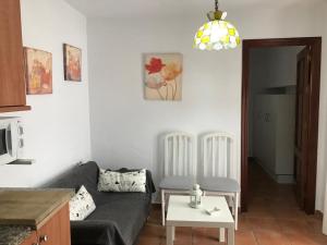 a living room with a couch and a table at Casa Calle Alta Maria Bajo in Vejer de la Frontera