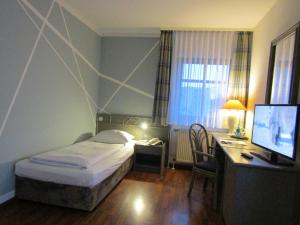 Postel nebo postele na pokoji v ubytování Art-Hotel Erlangen