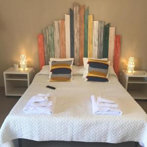 a bedroom with a bed with towels on it at la casa di mery in Tor Vergata