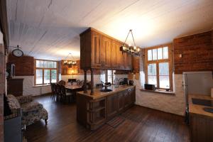 a kitchen with wooden cabinets and a dining room at AirHome - Water Tower in Sõrve