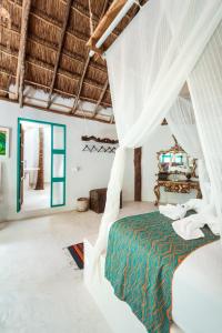 A bed or beds in a room at Hotel Cormoran Tulum & Cenote