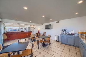a restaurant with tables and chairs and a counter at Americas Best Value Inn Uvalde in Uvalde