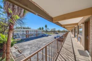 a balcony view of a building with a parking lot at Americas Best Value Inn Uvalde in Uvalde