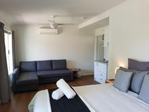 a living room with a bed and a couch at Fish Creek Adrift Accommodation in Fish Creek