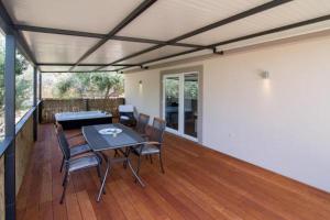 a patio with a table and chairs on a deck at Luxury Mobile Homes Liza in Biograd na Moru