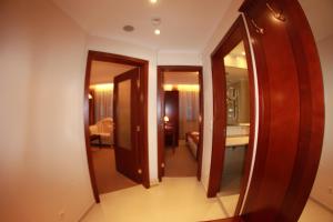 a hallway leading to a room with a mirror at Downtown Bansko Resort in Bansko +154 photos