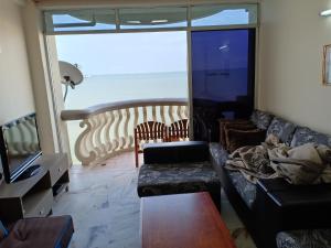 a living room with a couch and a view of the ocean at Glory 3 Room Seaview Getaway in Port Dickson