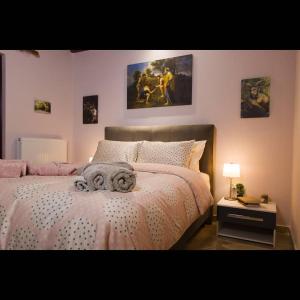 a bedroom with a large bed and a night stand at Villa Agno - Βίλα Αγνώ in Ãno KariaÃ­