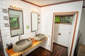 a bathroom with two sinks on a counter at Qamea Resort & Spa in Qamea