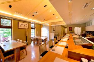 a large dining room with tables and chairs at Hot Cross Point Santa Monica in Miyako-jima
