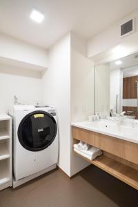 a bathroom with a washing machine and a sink at SO Kyoto Fushimi Inari in Kyoto