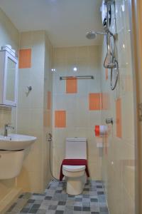 a bathroom with a toilet and a sink at Harrys Hotel Bar & Restaurant in Pattaya Central +27 photos