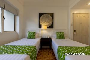 מיטה או מיטות בחדר ב-Orchid Garden Suites