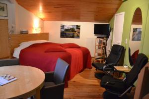 ein Schlafzimmer mit einem Bett, Stühlen und einem Tisch in der Unterkunft B&B Wepa-hof in Oud-Turnhout