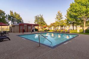 a swimming pool with a gazebo in a park at Comfort Suites NW Dallas Near Love Field in Dallas