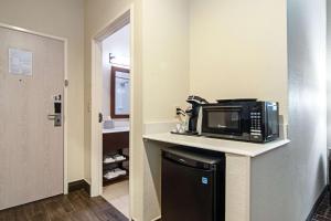 a microwave on a counter in a hotel room at Comfort Suites NW Dallas Near Love Field in Dallas