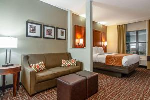 a hotel room with a bed and a couch at Comfort Suites NW Dallas Near Love Field in Dallas