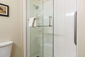 a shower with a glass door in a bathroom at Comfort Suites NW Dallas Near Love Field in Dallas