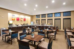 a restaurant with tables and chairs and a cafeteria at Comfort Suites NW Dallas Near Love Field in Dallas