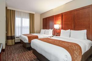 a hotel room with two beds and a window at Comfort Suites NW Dallas Near Love Field in Dallas