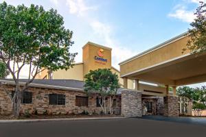 a building with a sign on the side of it at Comfort Suites NW Dallas Near Love Field in Dallas