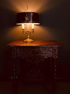 a table with a lamp on top of it at Moon and Chalice Boutique Hotel in Kunming