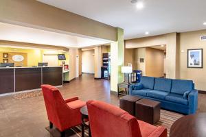 a hotel lobby with a blue couch and chairs at Comfort Suites NW Dallas Near Love Field in Dallas