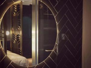 a room with a bed and a wall with a mirror at Moon and Chalice Boutique Hotel in Kunming