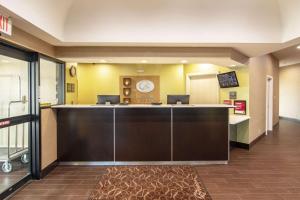 a kitchen with a white counter top and a black counter top at Comfort Suites NW Dallas Near Love Field in Dallas