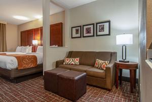 a hotel room with a bed and a couch at Comfort Suites NW Dallas Near Love Field in Dallas