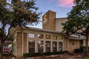 a building with a sign on the top of it at Comfort Suites NW Dallas Near Love Field in Dallas