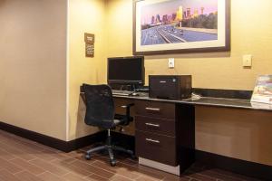 an office with a desk with a computer and a chair at Comfort Suites NW Dallas Near Love Field in Dallas